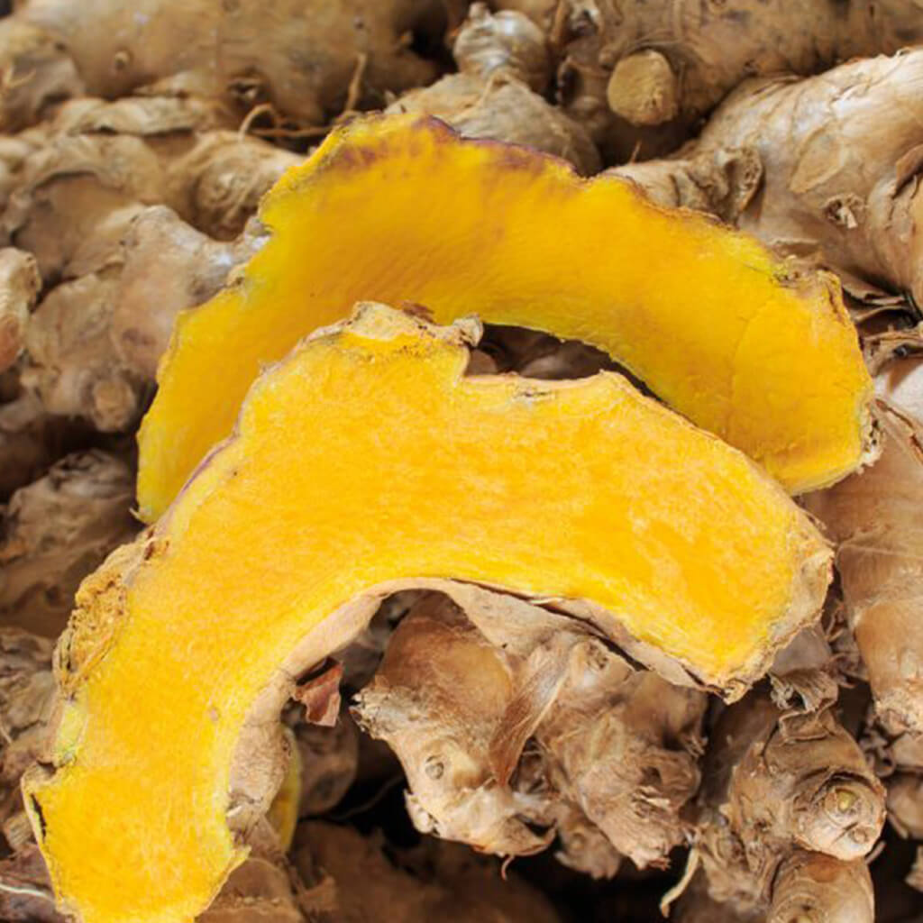 Fresh turmeric root slices for skin care and health