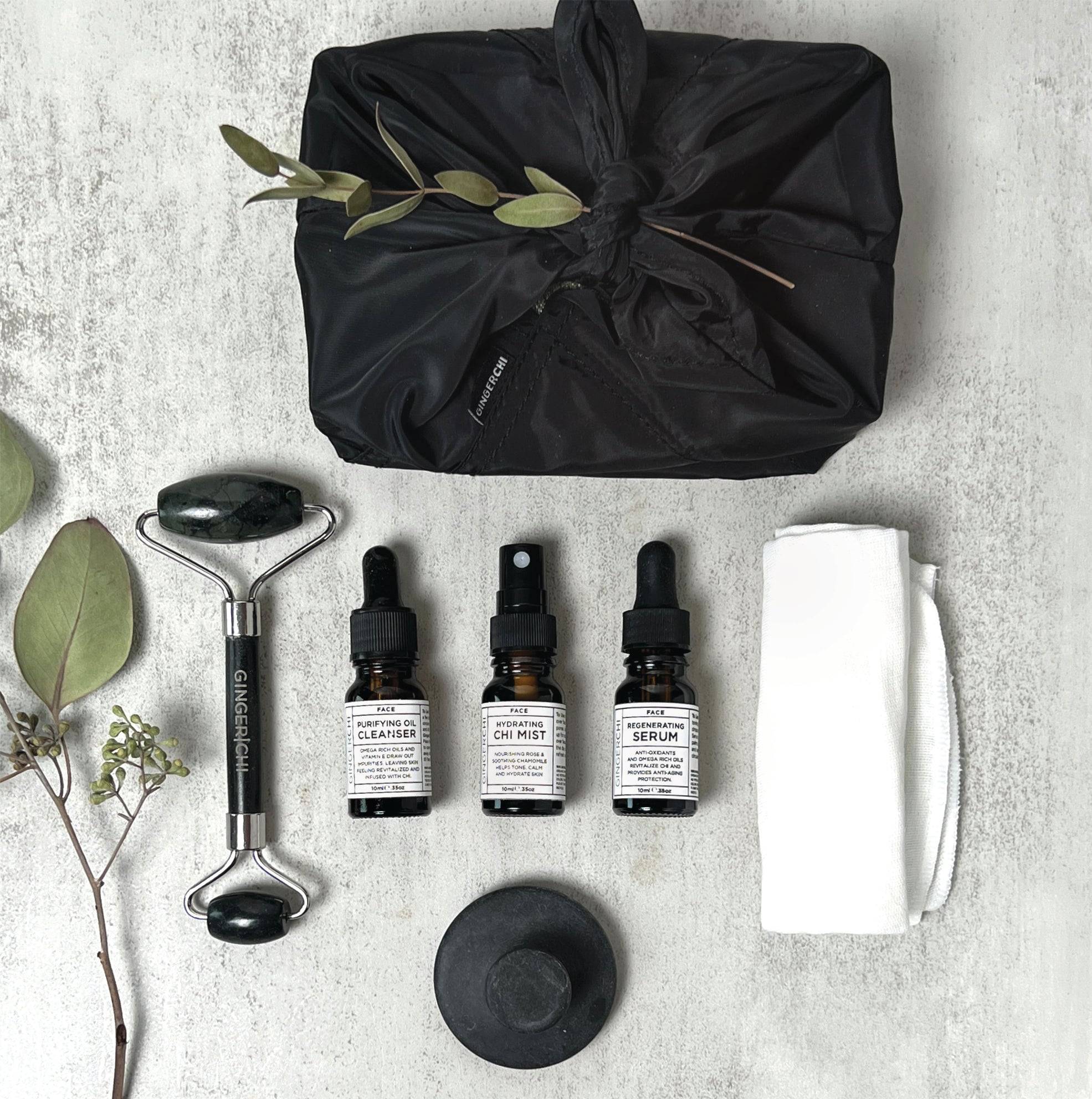 Black gift bag with green leaves and skincare tools