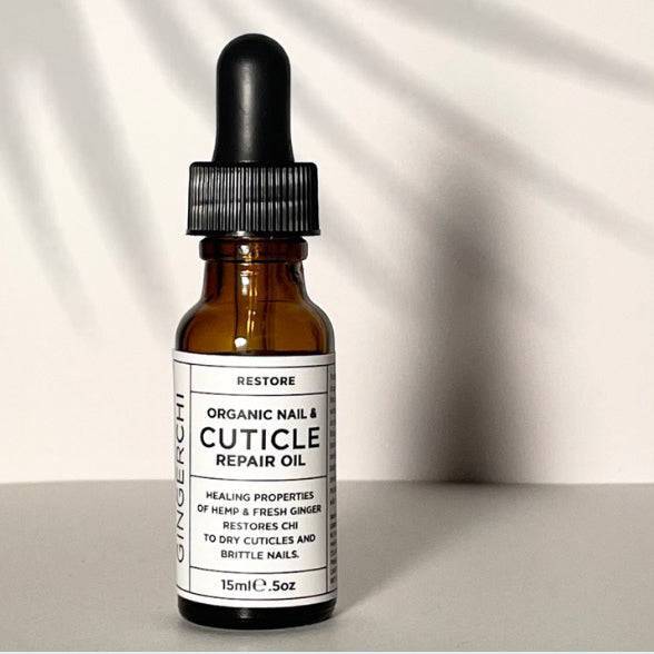 A bottle of GingerChi Organic Nail & Cuticle Repair Serum with a dropper cap, placed on a light background.