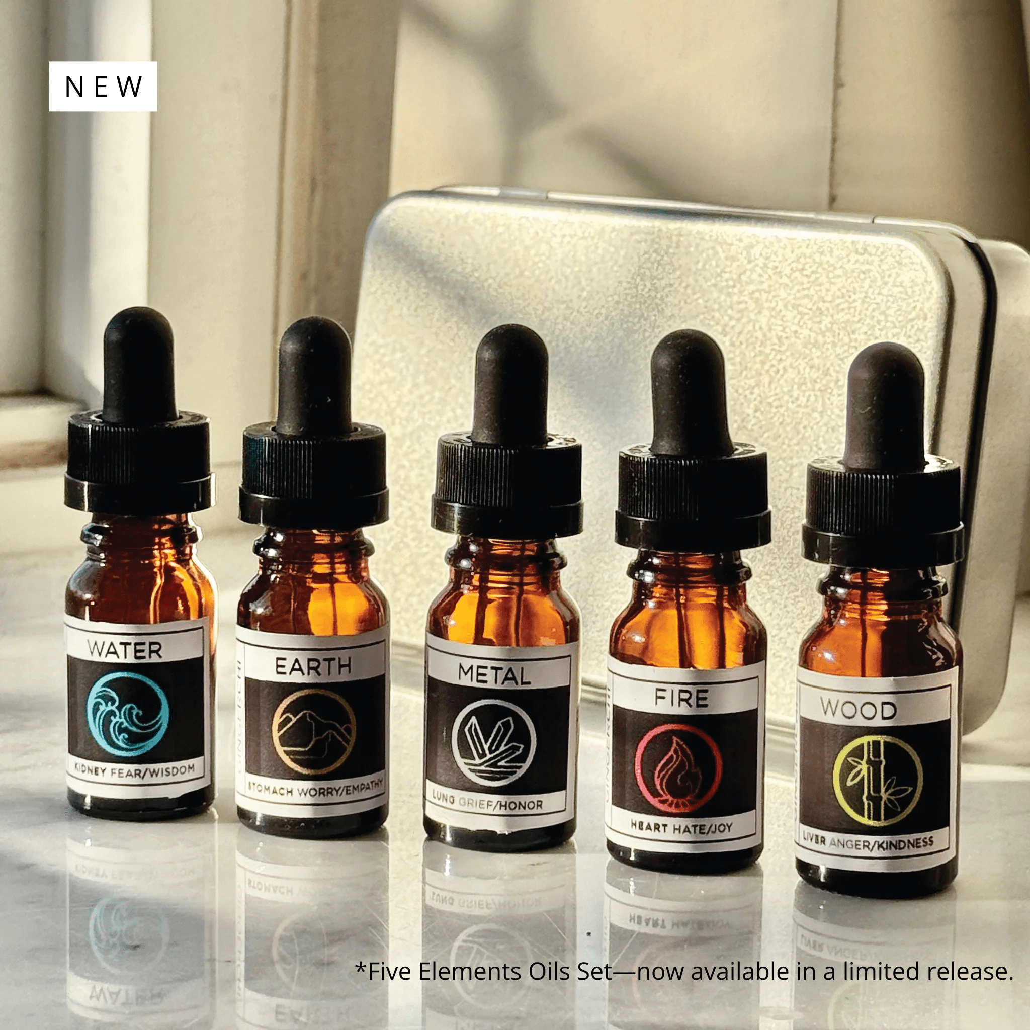 Essential oil bottles labeled Water, Earth, Metal, Fire, Wood